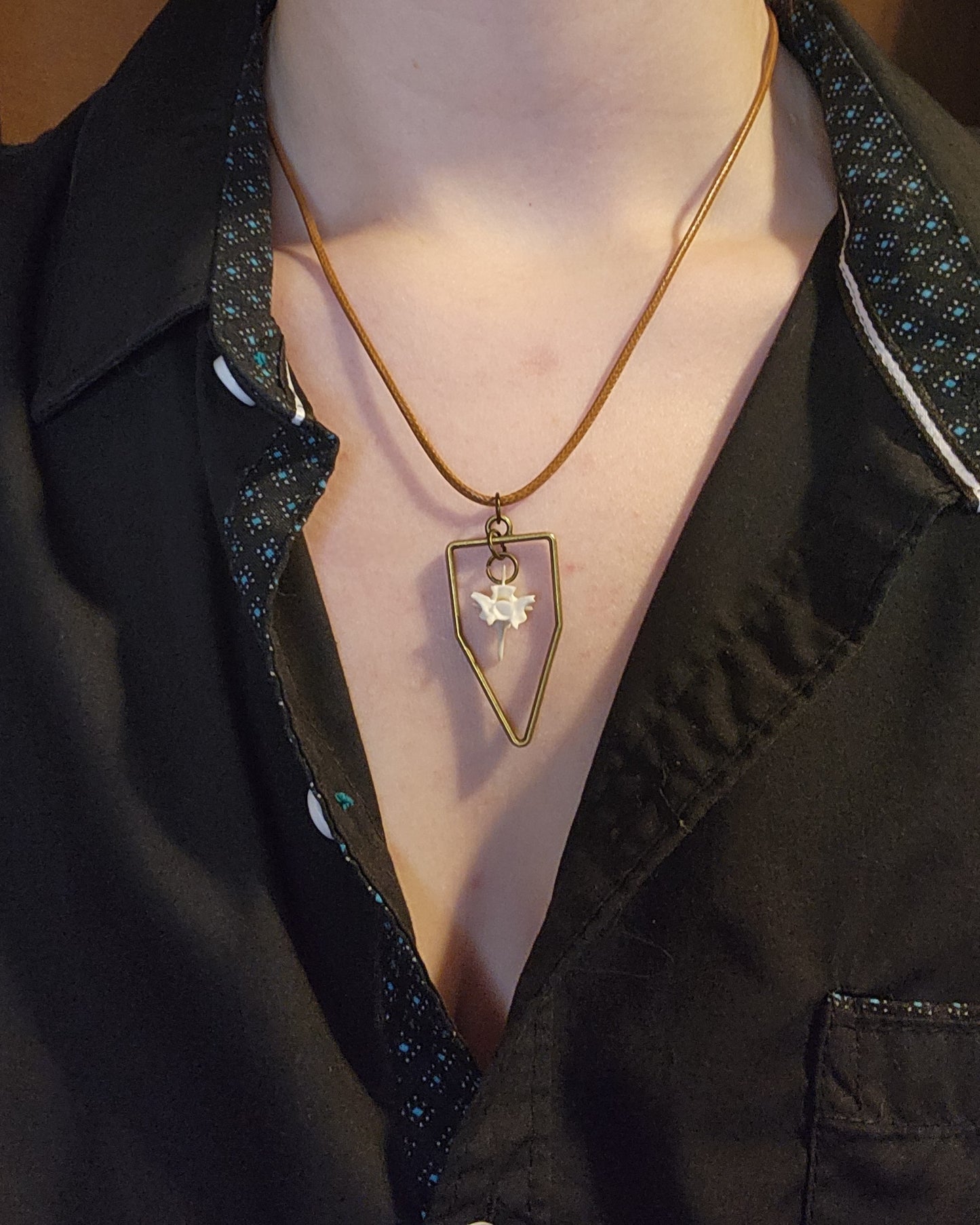 Suspended bone (leather cord)